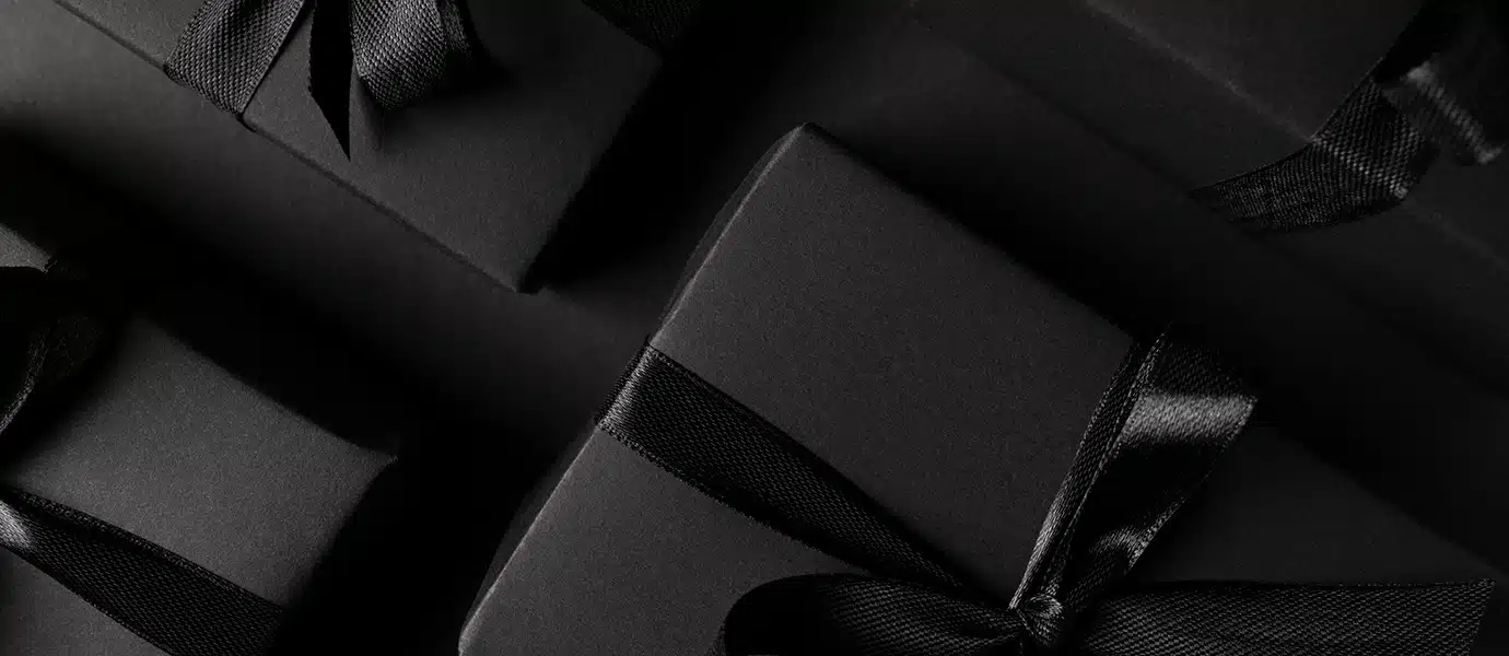 Black Gift boxes close up on dark background. This file is cleaned and retouched.